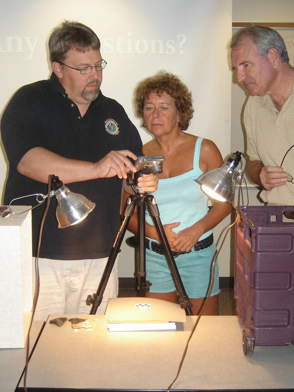 Demonstrating how to photograph artefacts during a NAS Part III course